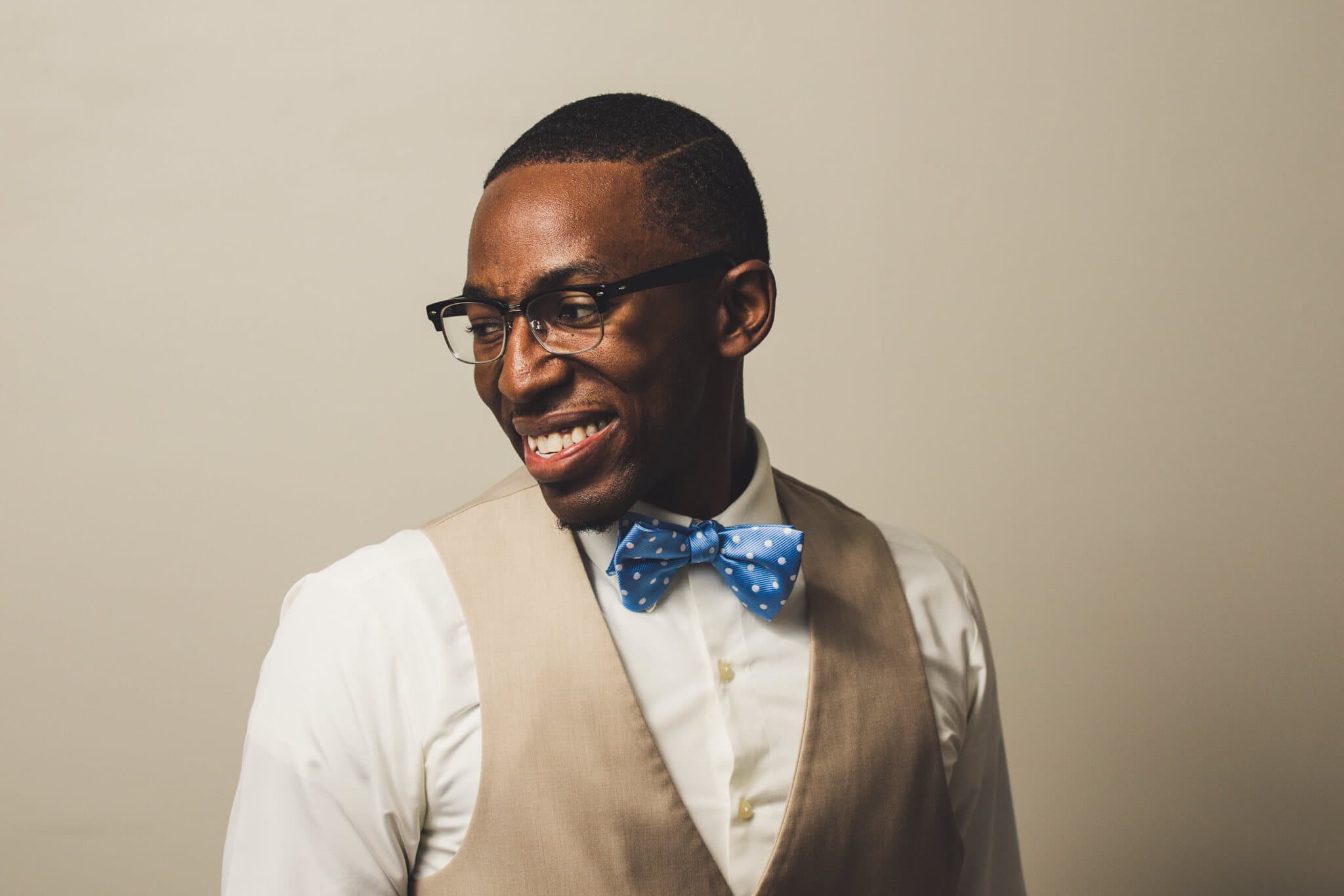 A head-shot of the photographer smiling looking down and to the left.